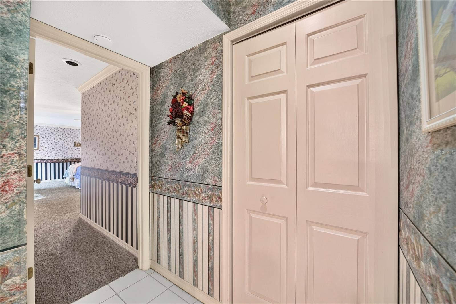 1708 NE 38TH AVENUE, Ocala, FL 34470 Entry into the primary bedroom. A closet is in the hall which is handy for everything.