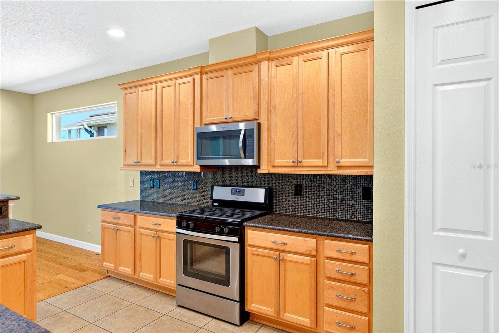 Spacious kitchen with gas-burning stove.