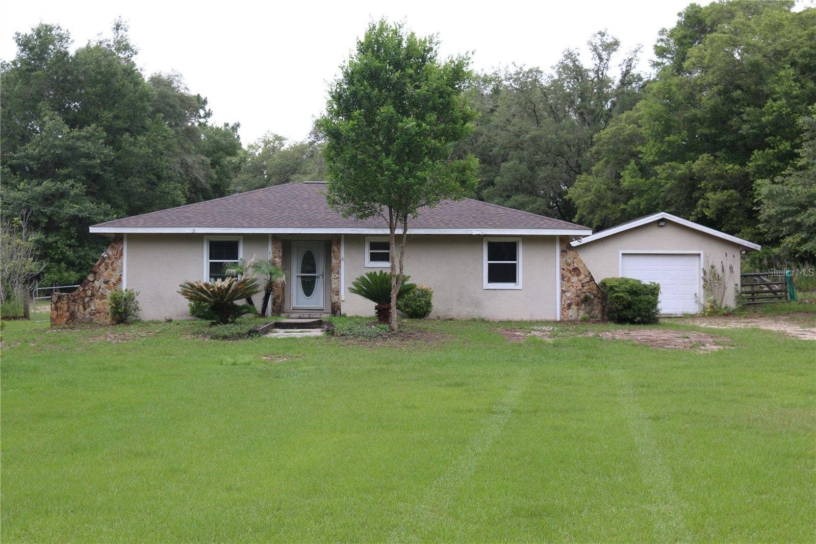7910 SW 202ND COURT, Dunnellon, FL 34431 FROM ENTRANCE 202ND CT LOOKING TO FRONT DOOR & ATTACHED GARAGE