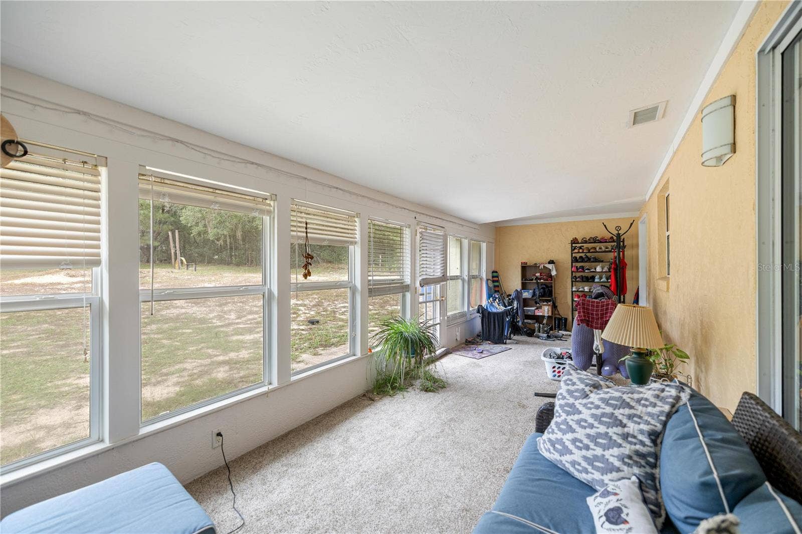 7910 SW 202ND COURT, Dunnellon, FL 34431 SUNROOM LOOKING TO PAST KITCHEN PASS-THRU WINDOW TO INSIDE LAUNDRY ROOM