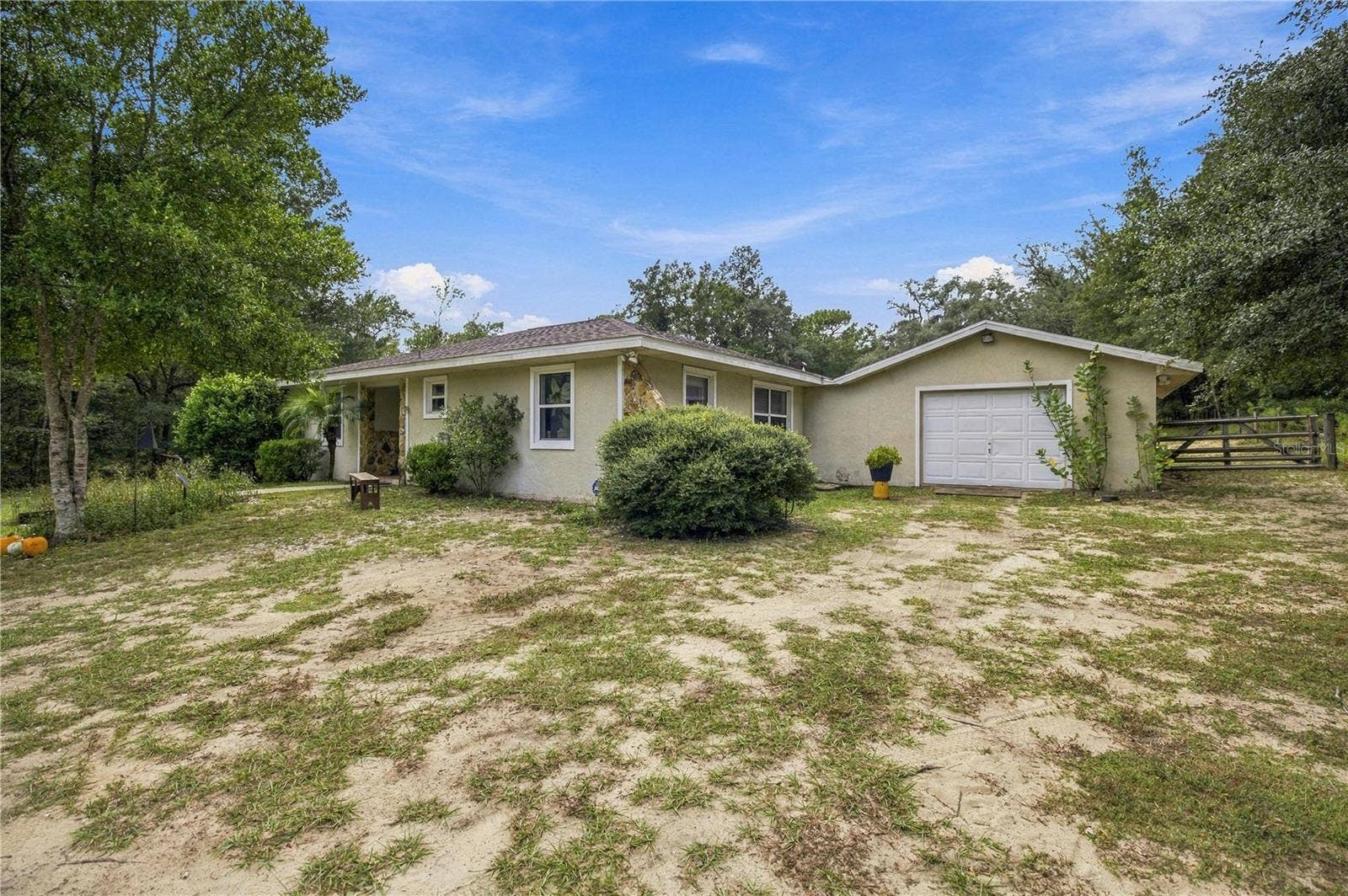 7910 SW 202ND COURT, Dunnellon, FL 34431 FROM DRIVEWAY TO GARAGE AND NE CORNER OF HOME