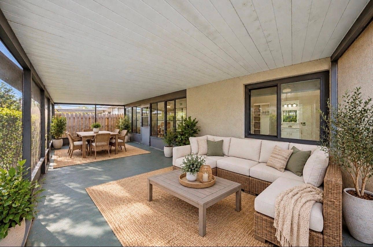 Expansive outdoor living with a screened room. Virtually staged for decorating ideas!