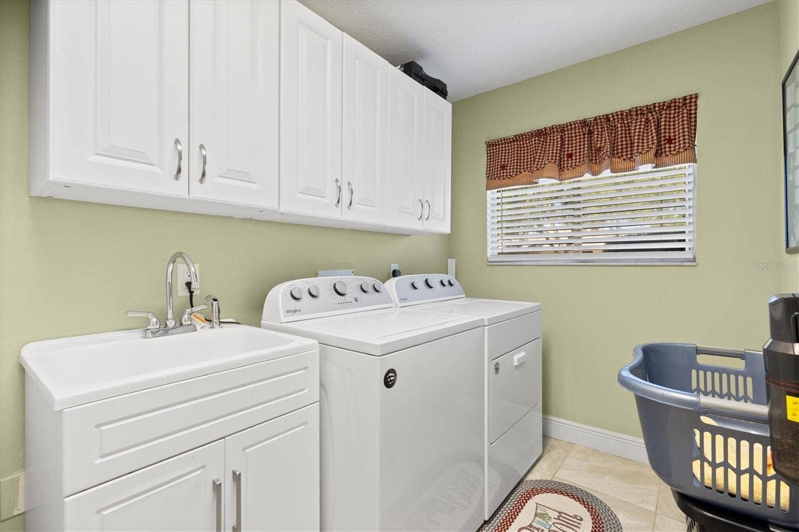 17432 SE 112TH COURT, Summerfield, FL 34491 Inside laundry room with utility sink.
