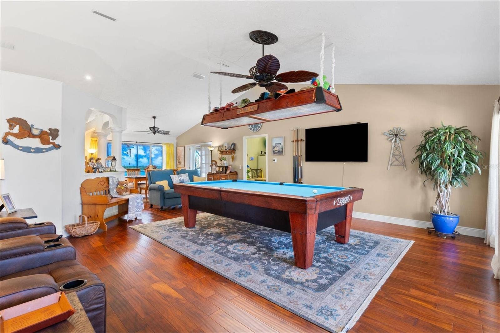 17432 SE 112TH COURT, Summerfield, FL 34491 Living room with engineered hardwood floors, vaulted ceilings. Currently being utilized for a billiard room. (pool table negotiable.)