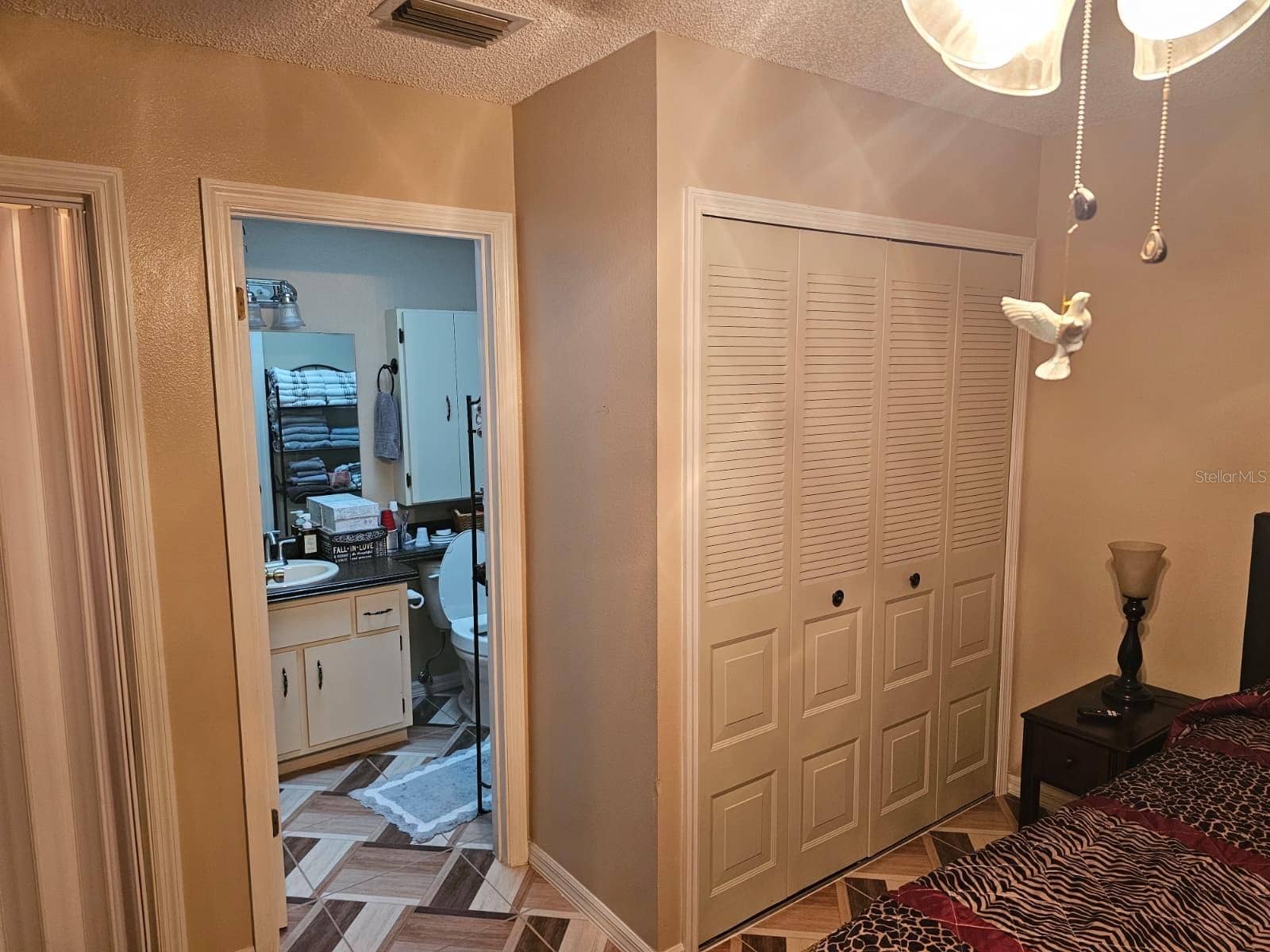 Primary bedroom with closet and door to bathroom