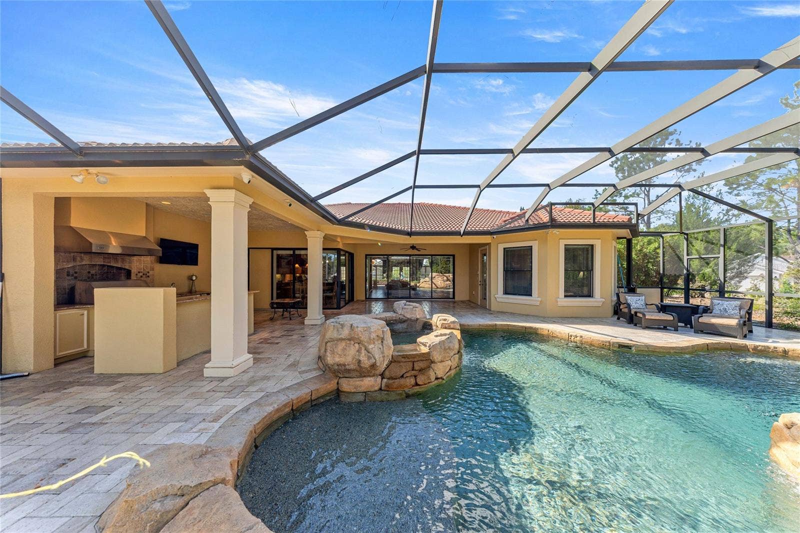 Screened Pool Area  Large screened enclosure with paver decking and views of the pool.
