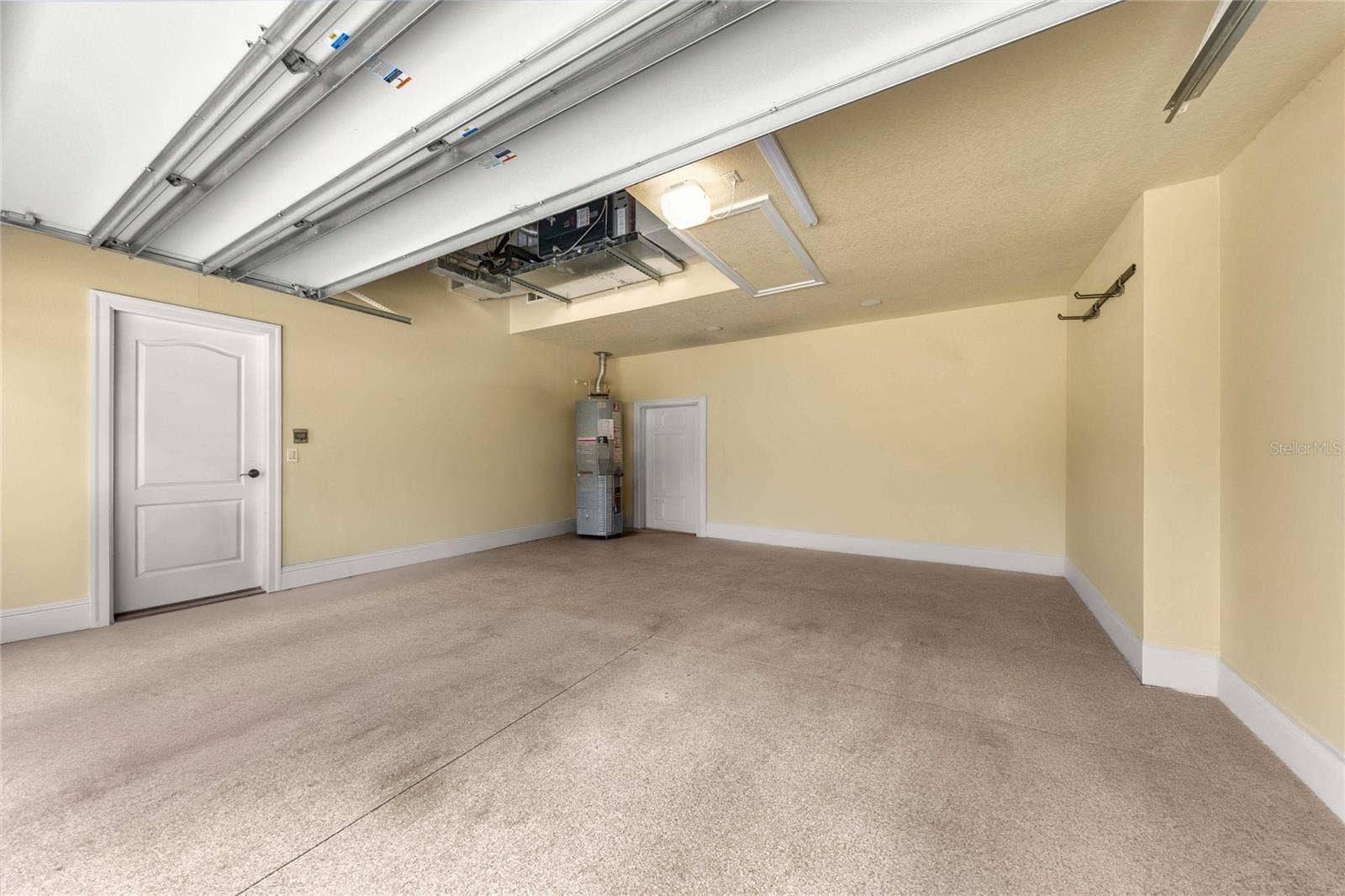 Garage  Spacious garage with finished walls and ample room for vehicles and storage.