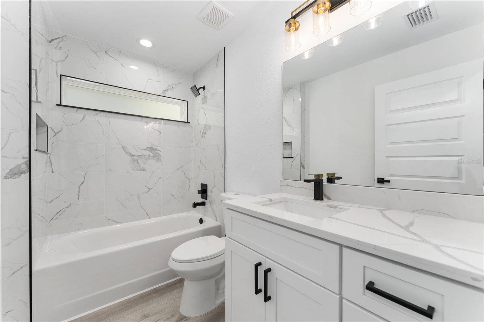3 PECAN DRIVE TRCE, Ocala, FL 34472 Guest Bath. Actual home will not have gold finishes, only black
