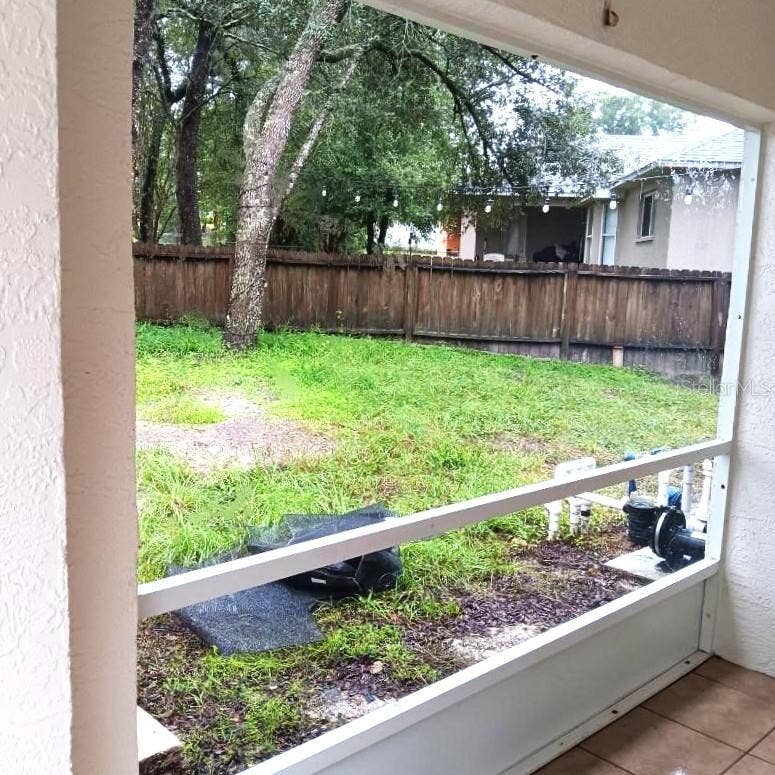 8919 N MENDOZA WAY, Citrus Springs, FL 34434 Looking out sliding doors from dining area across lanai to fenced back yard.