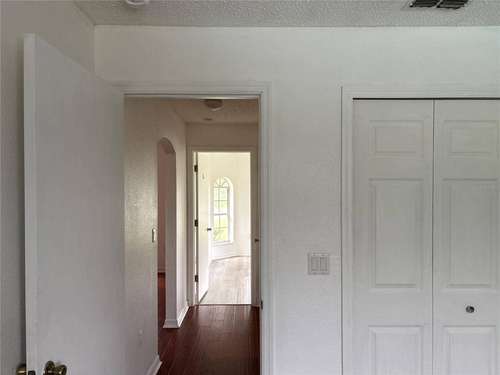 8919 N MENDOZA WAY, Citrus Springs, FL 34434 From second bedroom looking down hallway toward guest bath and first guest bedroom