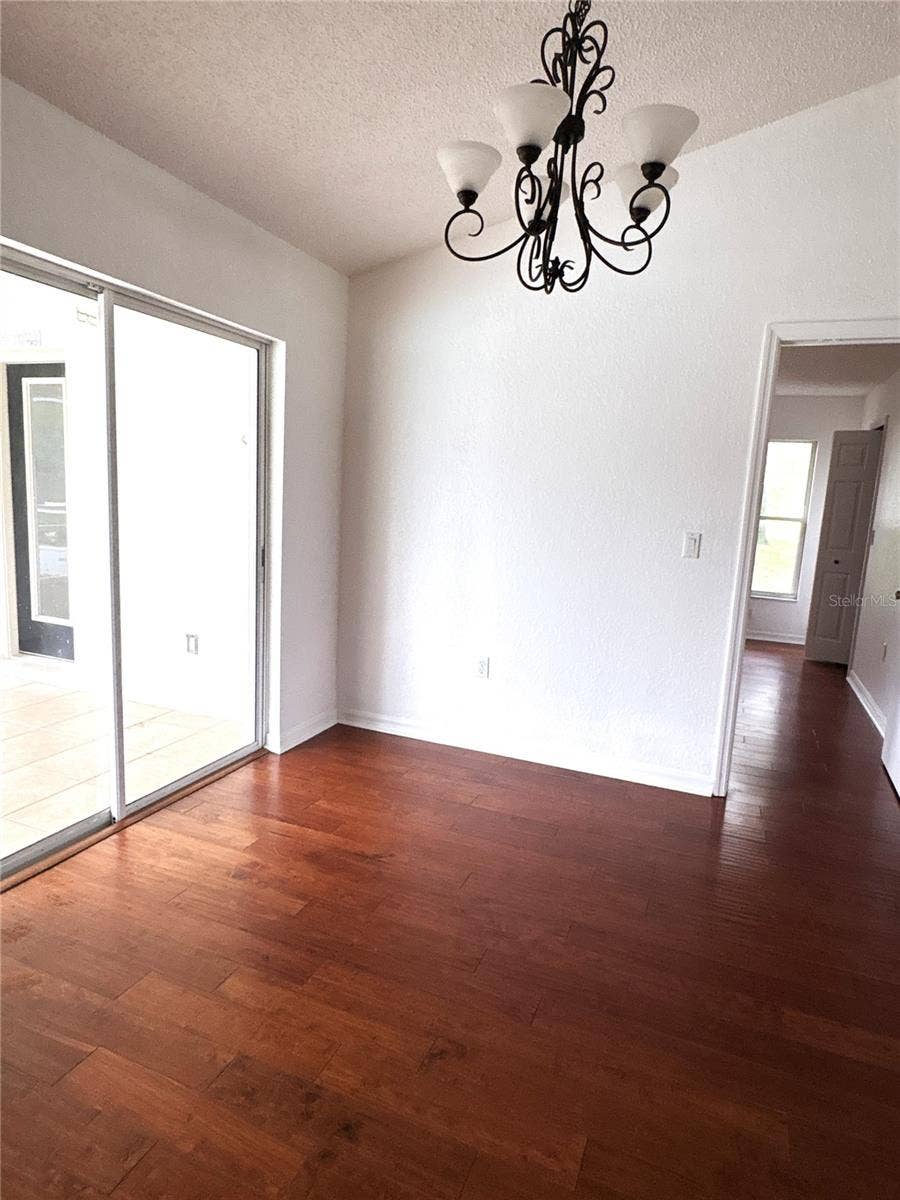 8919 N MENDOZA WAY, Citrus Springs, FL 34434 From kitchen looking across dining area to primary bedroom entrance.