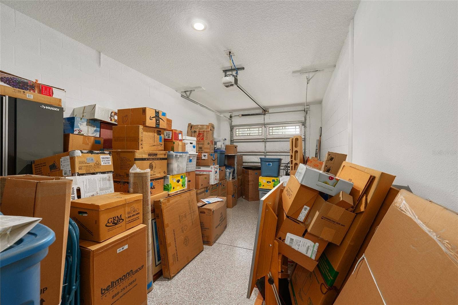 Extra-deep third-car garage featuring epoxy flooring, recessed lighting, and a dedicated golf-cart electrical outlet. Ideal for golf cart parking, an additional vehicle, or generous storage space.