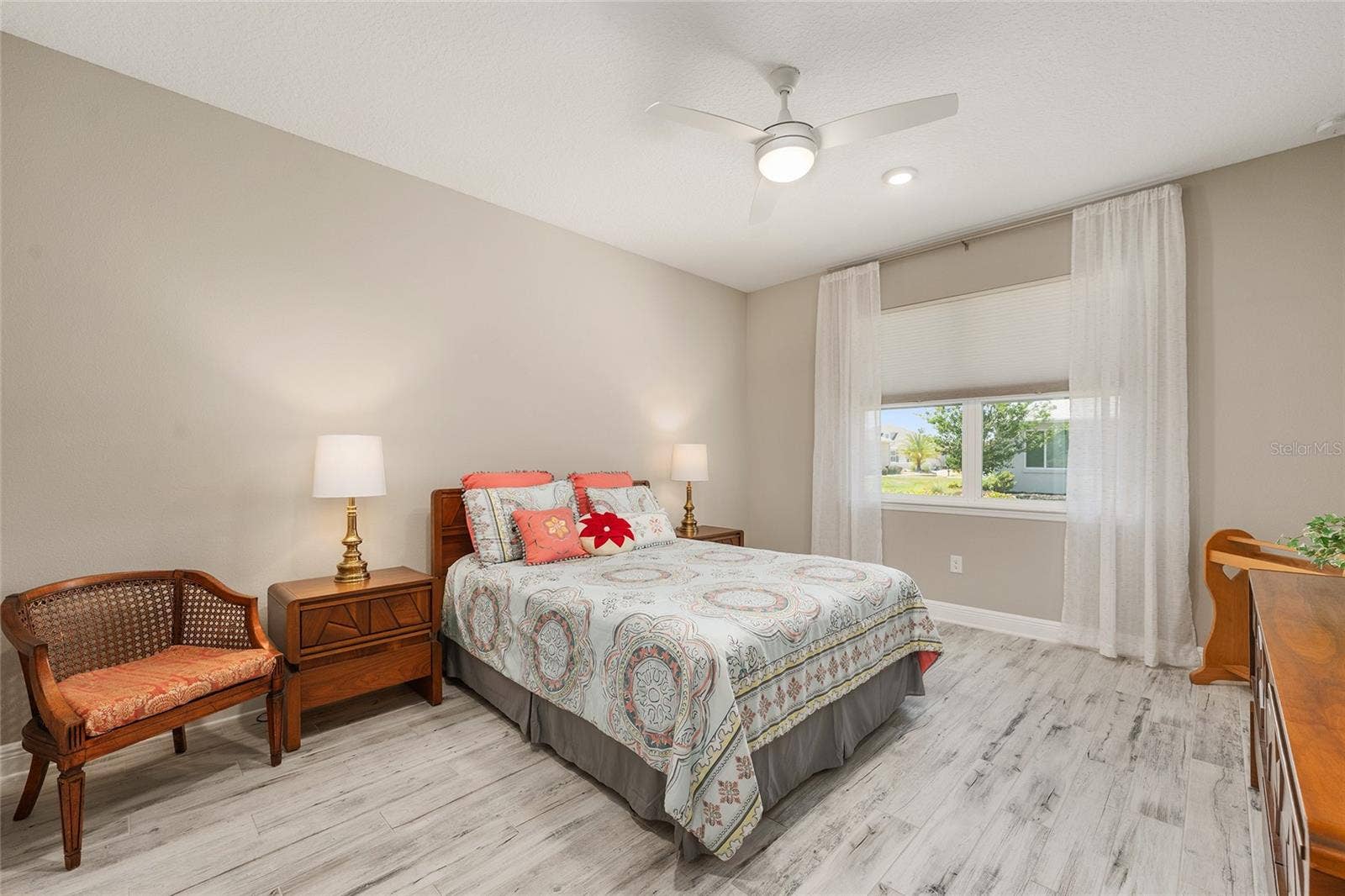 Spacious second primary suite featuring ceramic plank flooring, a ceiling fan with integrated lighting, and a large window that welcomes natural light. Complete with a private ensuite bathroom, this inviting retreat offers comfort and privacy for extended guests or multigenerational living.