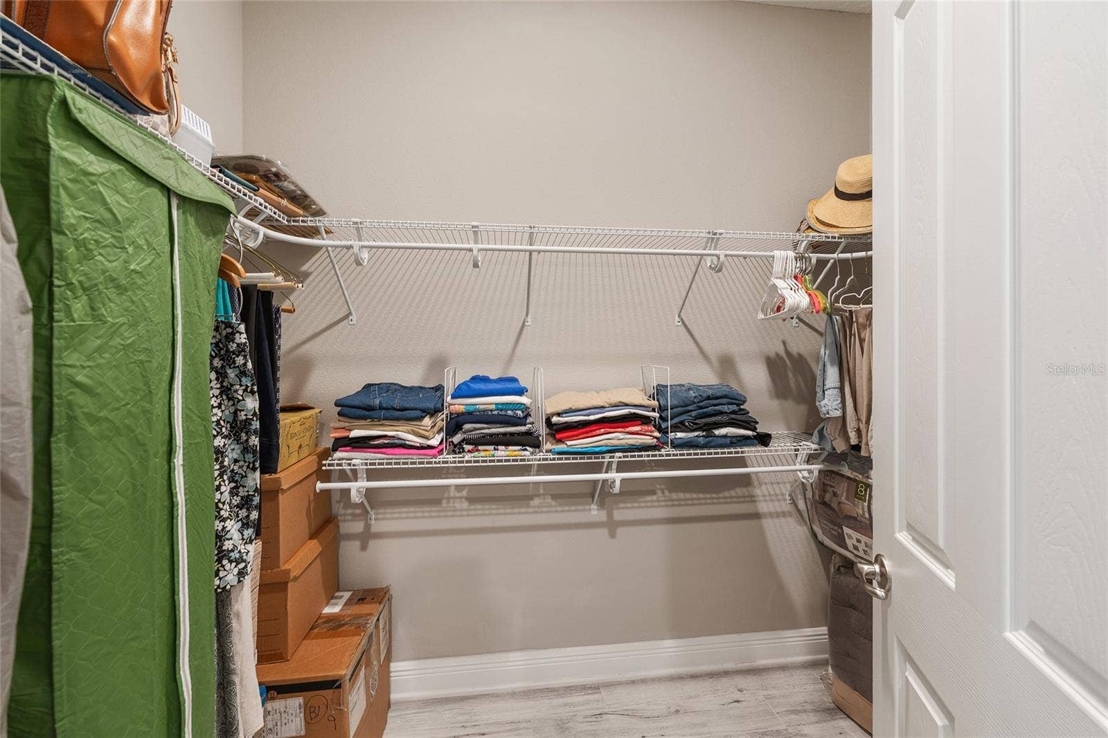 Second walk-in closet in the primary suite, offering additional shelving and hanging space to keep clothing and accessories neatly organized.
