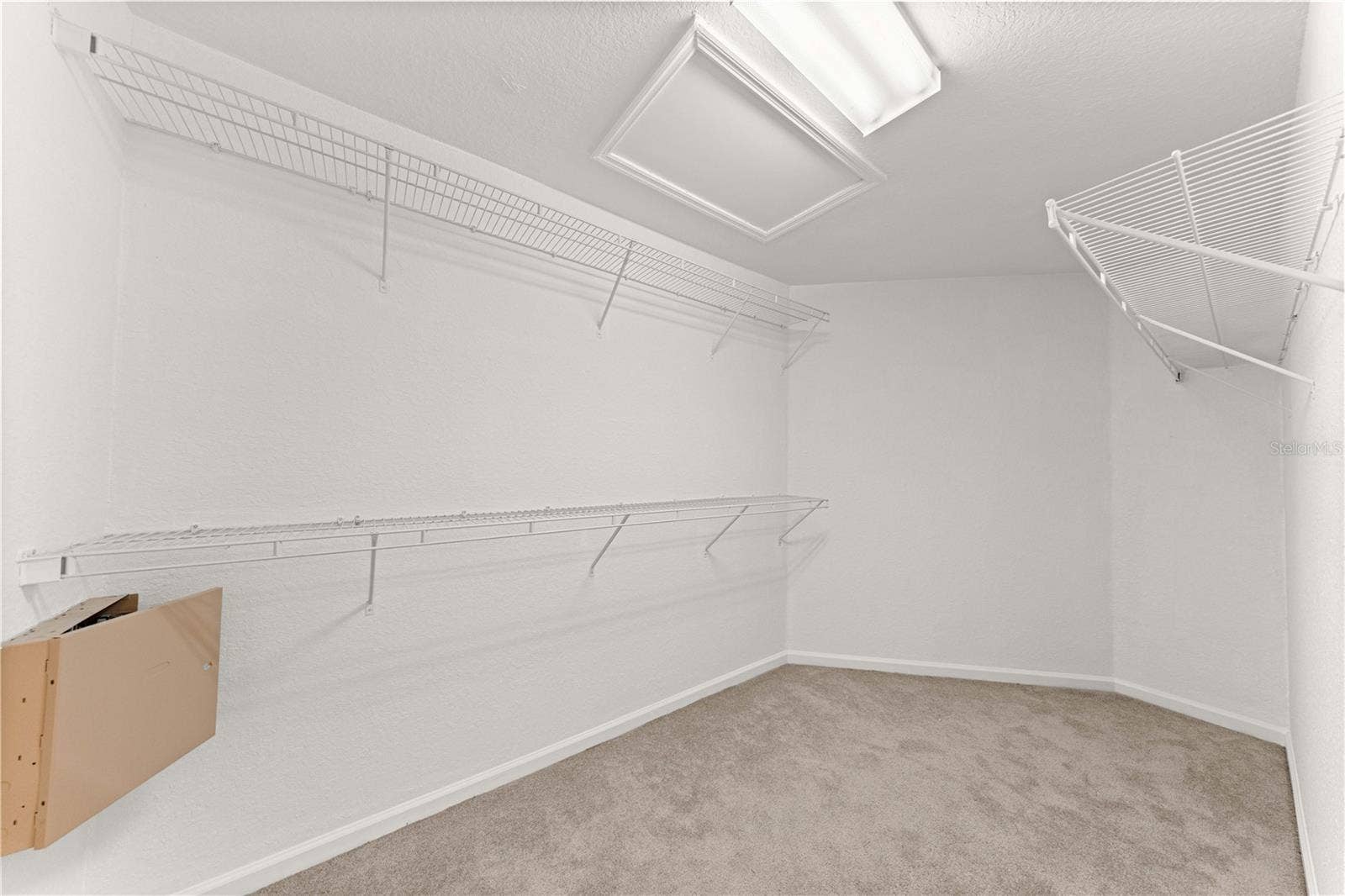 HUGE HUGE walk in primary closet with built in shelving