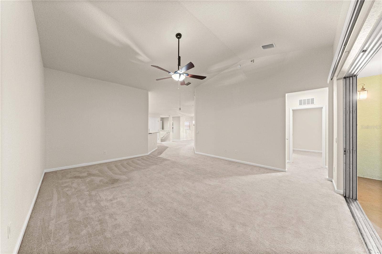 Living Room with telescoping sliding doors to screened in back patio