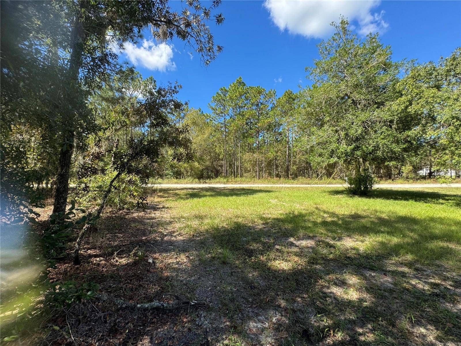 Lot 21 SW 157TH COURT, Ocala, FL 34481 LOT 21 LOOKING FROM REAR NE CORNER OF LOT 21. A .24 ACRE LOT (EAST TSIDE) TO FRONT AND BACK, (WEST SIDE) OF LOT. TO THE RIGHT (NORTH SIDE OF LOT), IS NEIGHBORING PROPERTY. TO THE LEFT IS 2615 SW 15TH CT HOME FOR SALE ALSO. BOTH PROPERTIES CAN BE SOLD TOGETHER OR SEPARATE