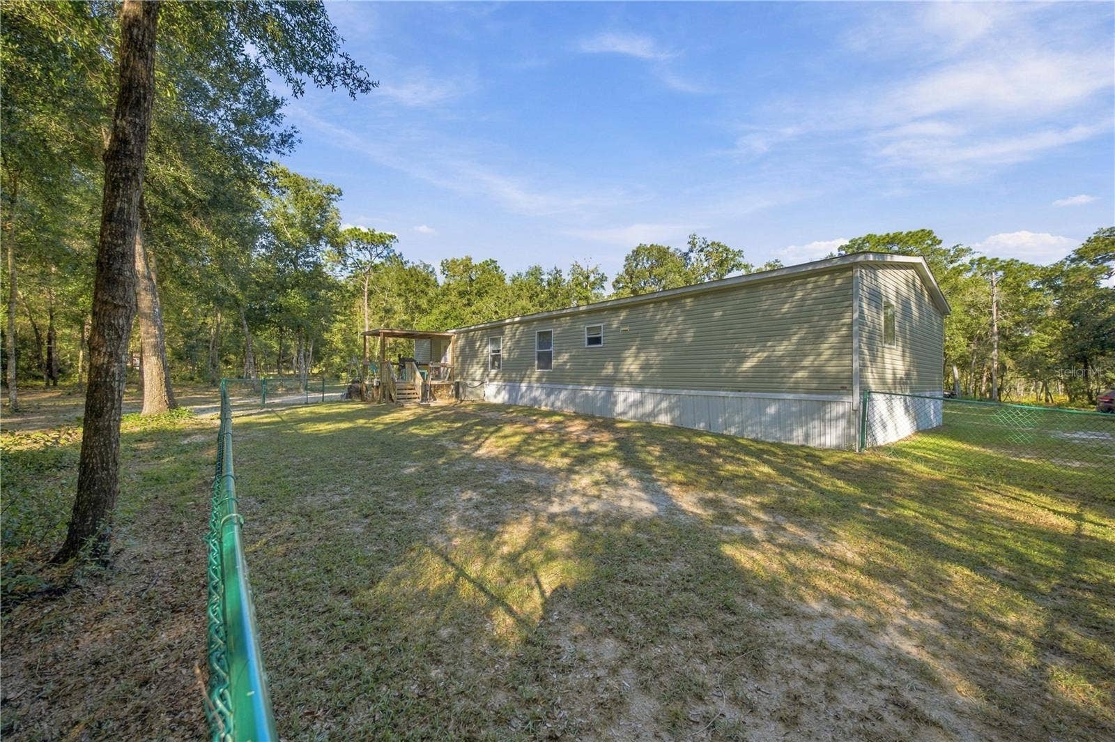 9921 SE 160TH AVENUE, Ocklawaha, FL 32179 FENCED AREA IN BACK OF HOME