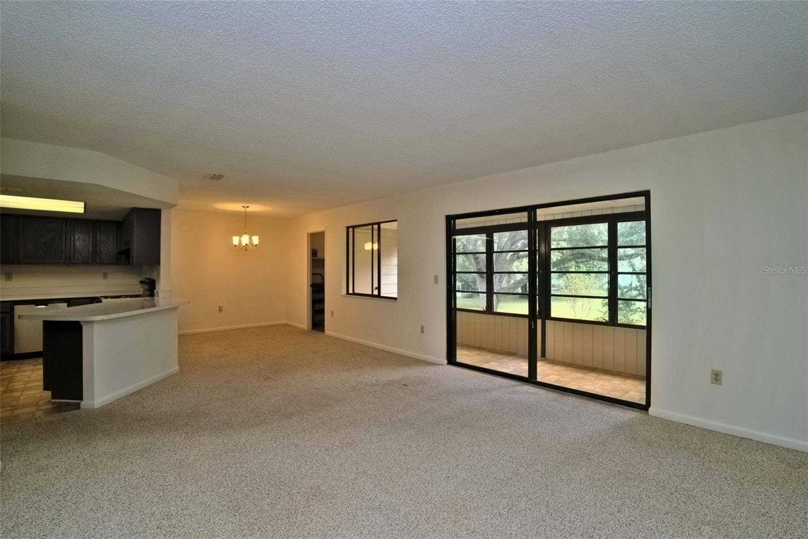 516 SILVER COURSE, #B, Ocala, FL 34472 Family Room, Looking at Dining Room, Sliding Glass Doors Lead to Lanai on the right