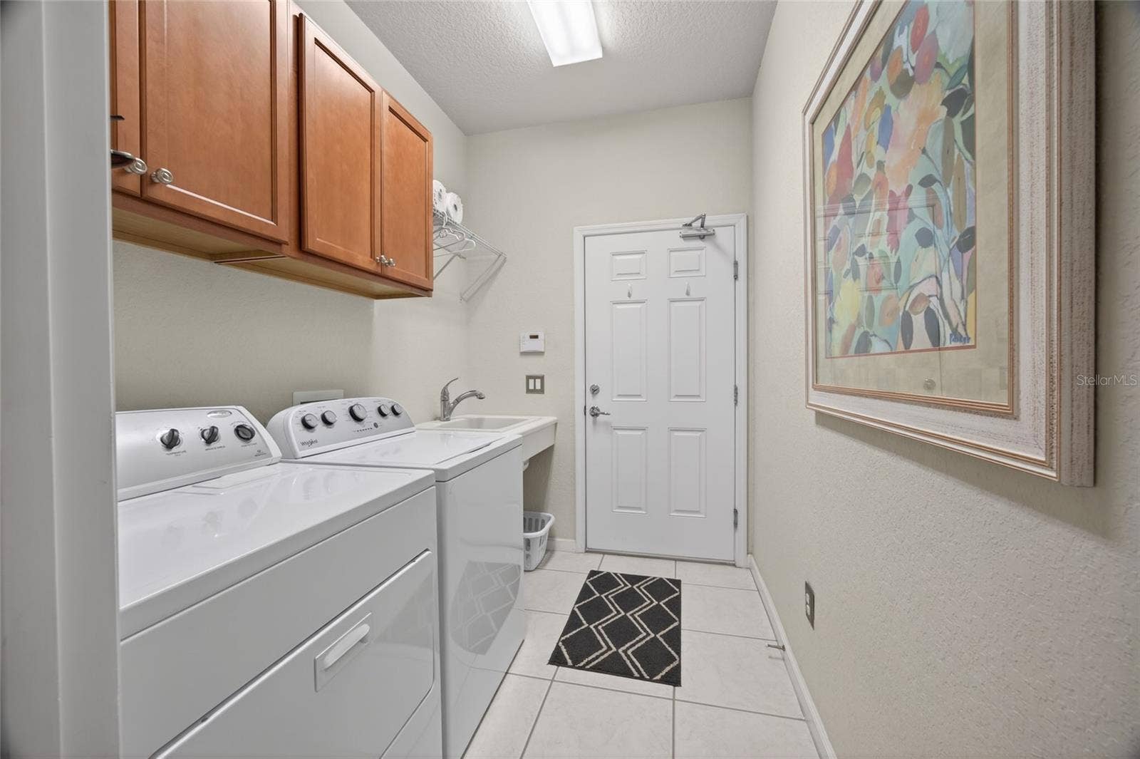 9106 SW 65TH LOOP, Ocala, FL 34481 Laundry room with storage cabinets. 2 car garage.