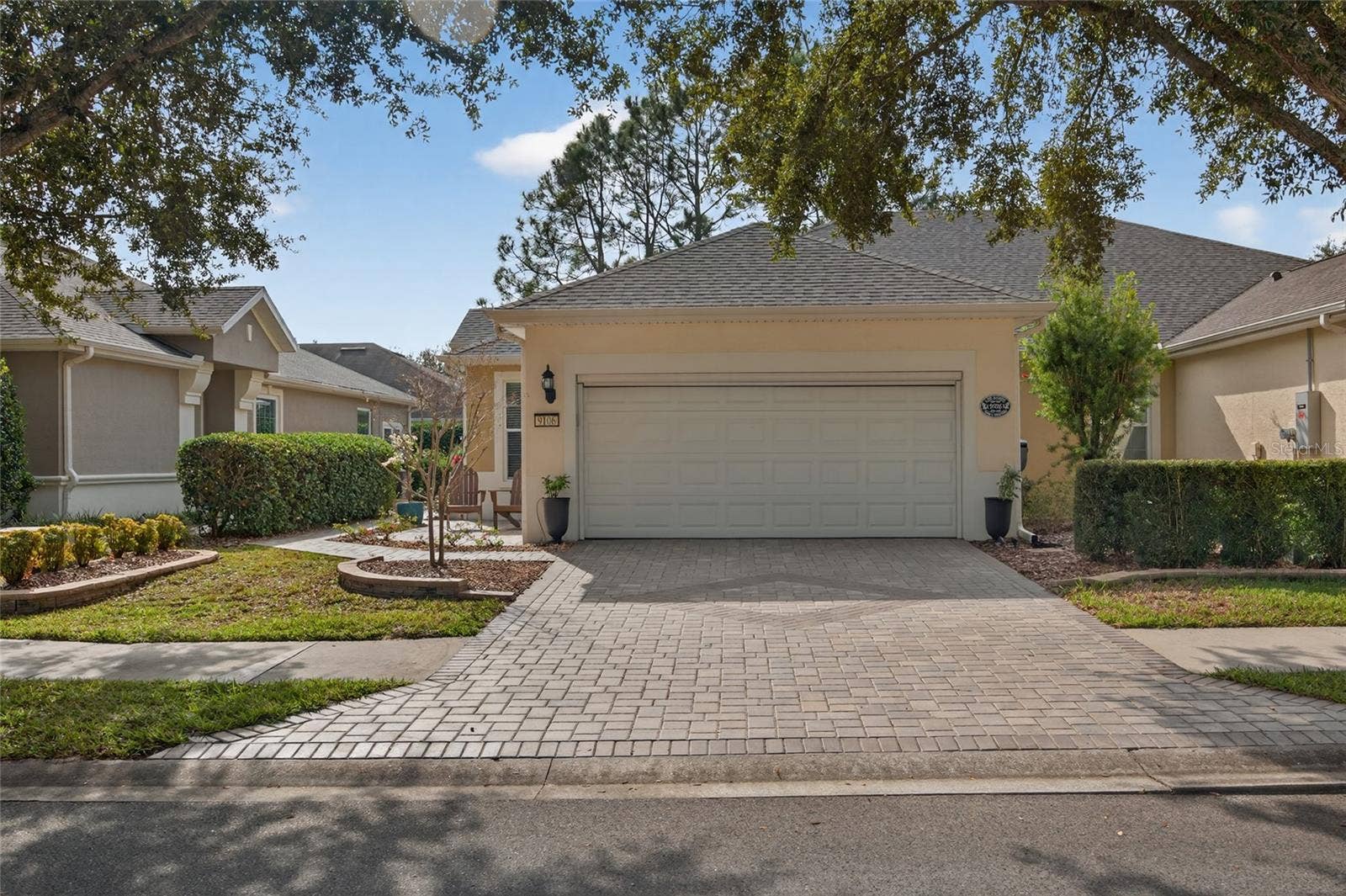 9106 SW 65TH LOOP, Ocala, FL 34481 Front of villa with with pavers on driveway