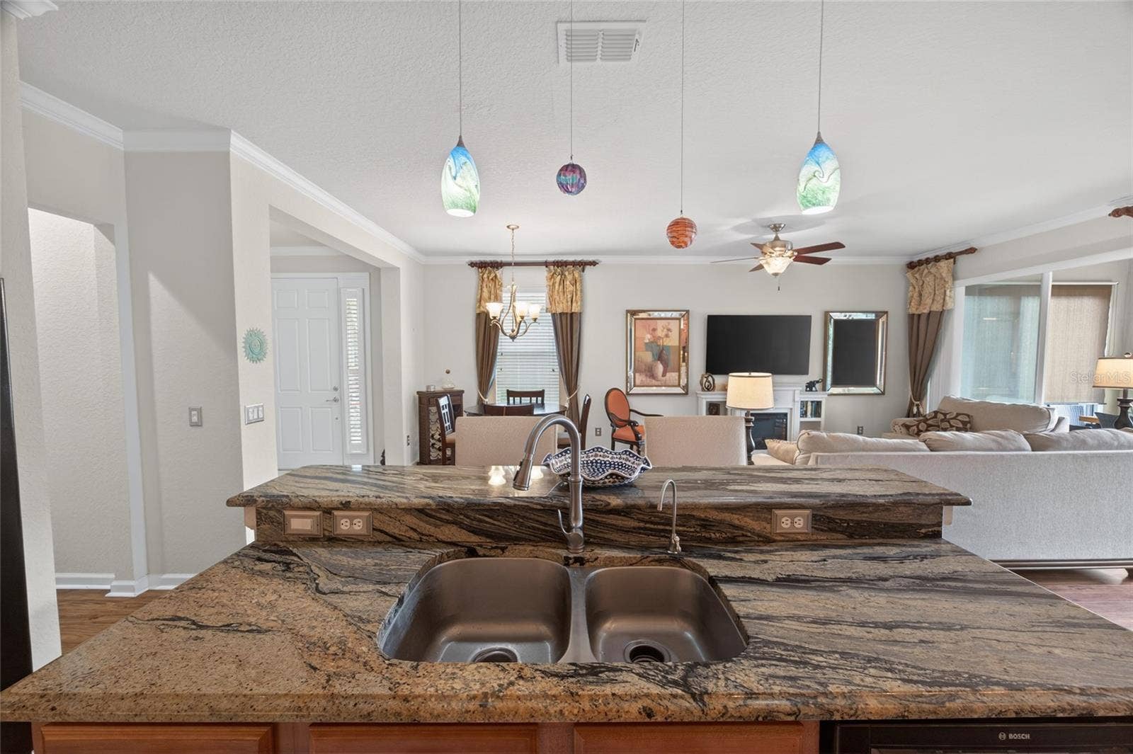 9106 SW 65TH LOOP, Ocala, FL 34481 This home has an extended patio that is enclosed with glass doors that stack to open for lots of fresh air and sunshine.