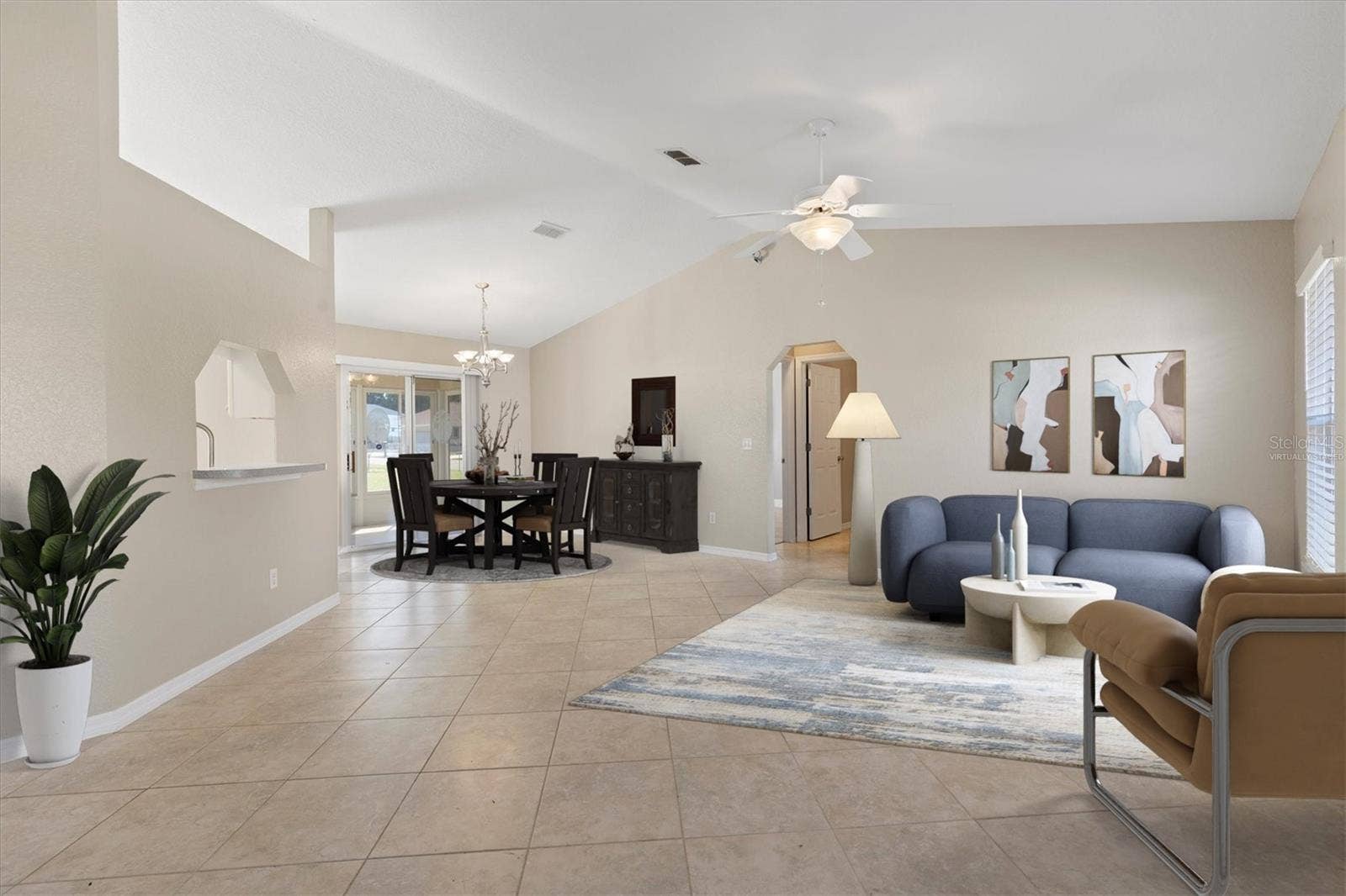 17501 SE 110TH COURT, Summerfield, FL 34491 Virtually staged living room with dining room.