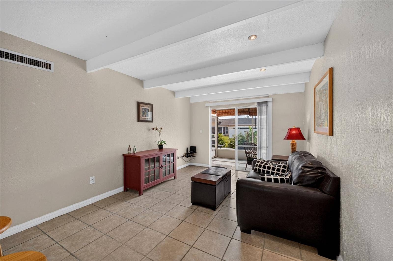 4409 CLUB CIRCLE, Lake Wales, FL 33898 Sliding glass door at the end of the living room allows natural light to filter inside the home.