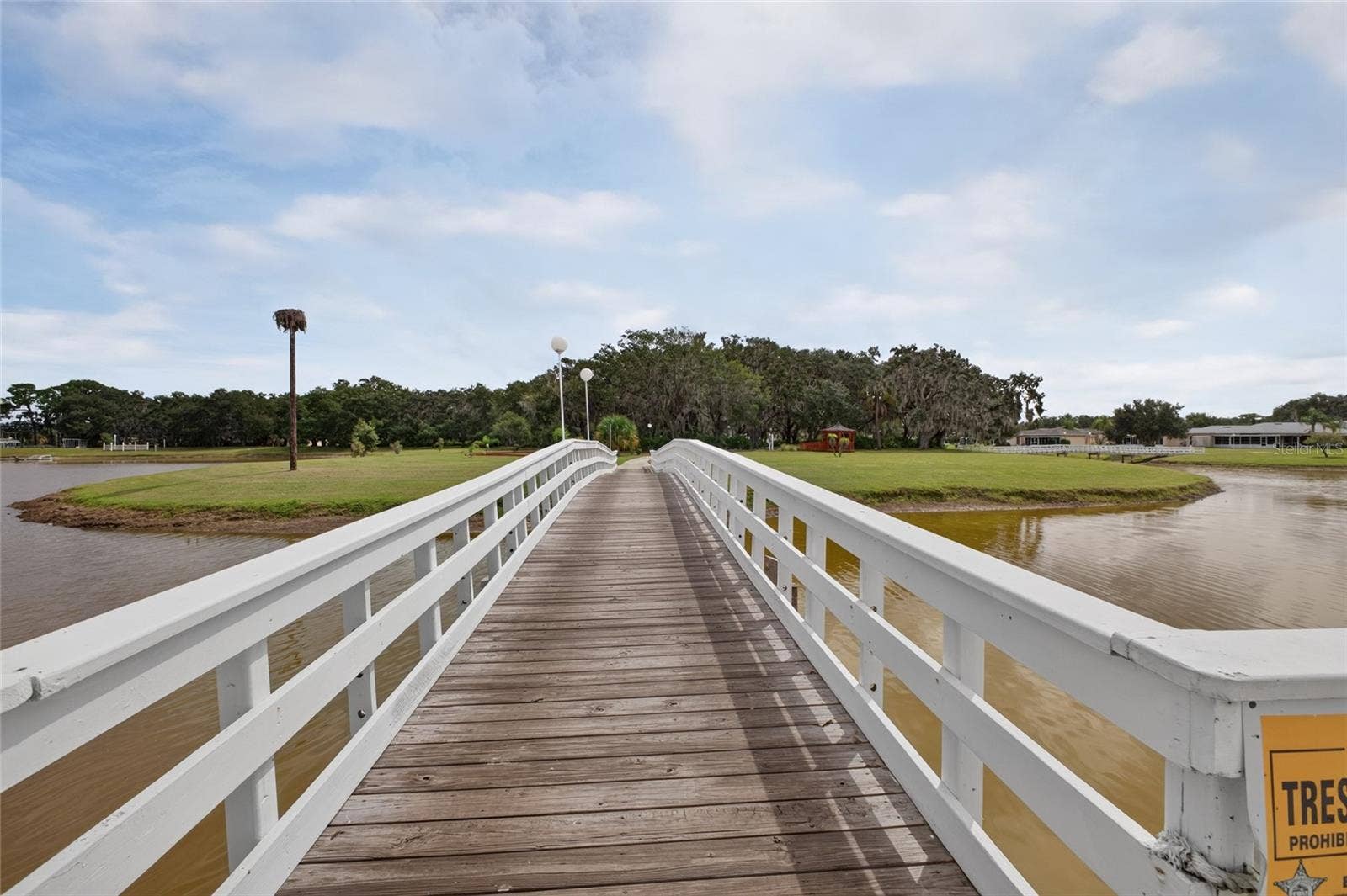 4409 CLUB CIRCLE, Lake Wales, FL 33898 Heading over the bridge to the "Island". Outdoor amenities are located on the Island and easily accessible from all homes.