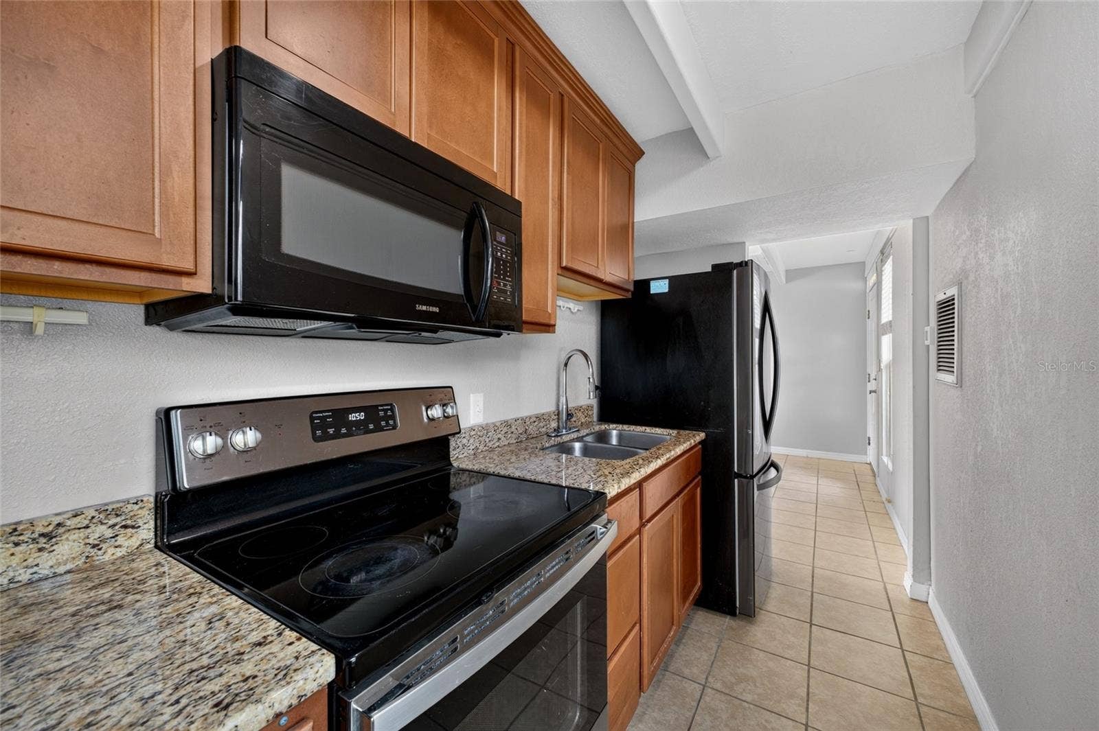 4409 CLUB CIRCLE, Lake Wales, FL 33898 Granite Countertops. Stainless steel / black kitchen appliances including a built in microwave.