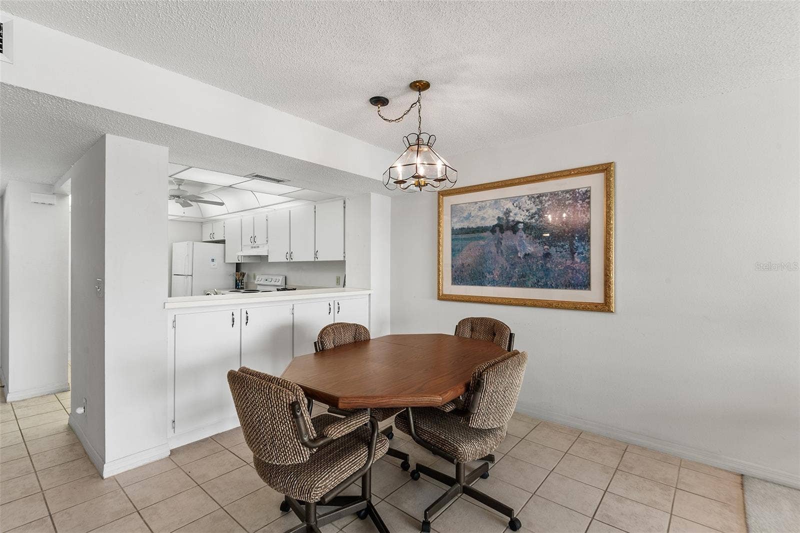 1776 6TH STREET NW, #304, Winter Haven, FL 33881 DINING AREA. NOTE EXTRA CABINET STORAGE BELOW PASS THRU FROM KITCHEN