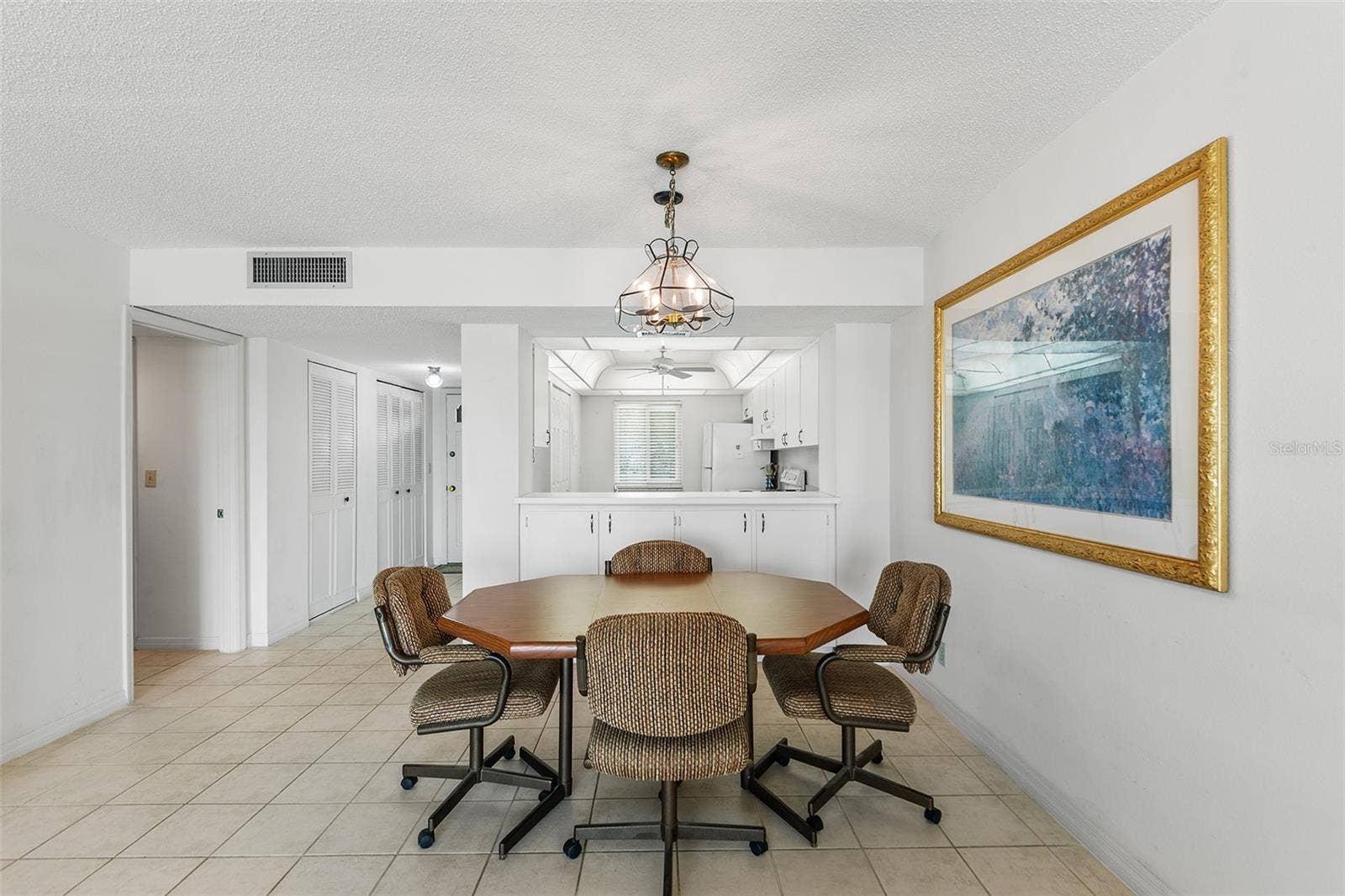 1776 6TH STREET NW, #304, Winter Haven, FL 33881 VIEW TOWARDS DINING AREA, KITCHEN, FRONT ENTRY CLOSET STORAGE