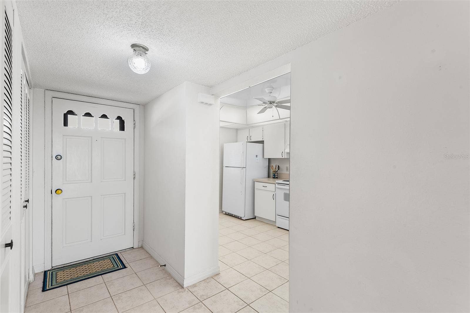 1776 6TH STREET NW, #304, Winter Haven, FL 33881 VIEW TOWARDS FOYER AND KITCHEN