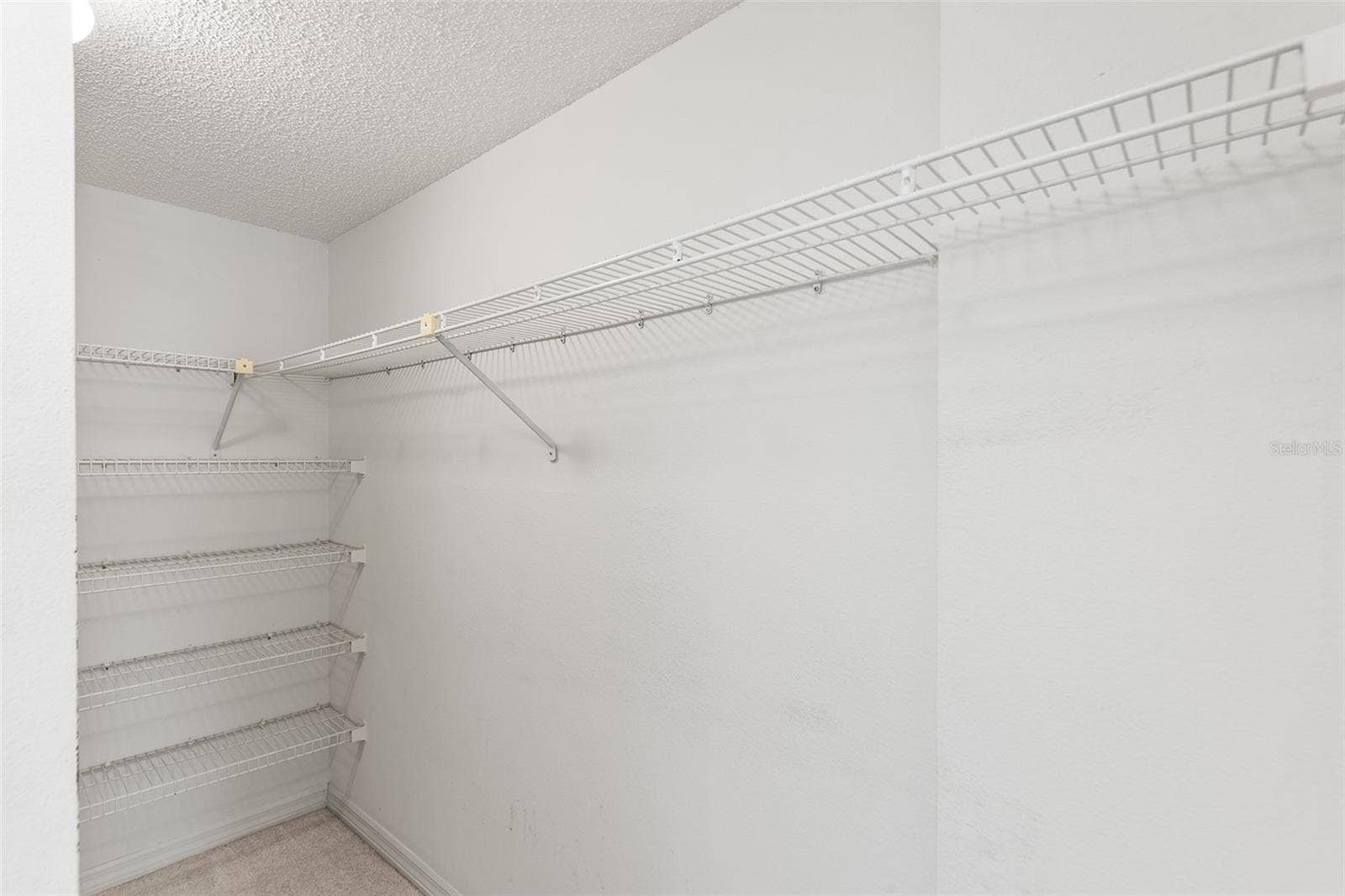 1776 6TH STREET NW, #304, Winter Haven, FL 33881 PRIMARY BEDROOM SUITE WALK-IN CLOSET