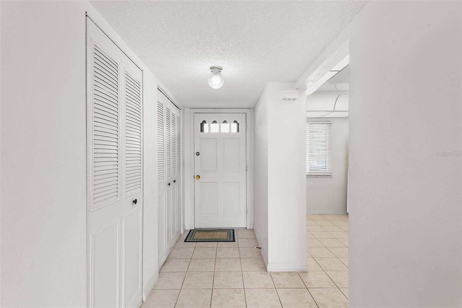 1776 6TH STREET NW, #304, Winter Haven, FL 33881 VIEW TOWARDS FRONT ENTRY FOYER. CLOSET STORAGE ON LEFT. ENTRY TO KITCHEN ON THE RIGHT.