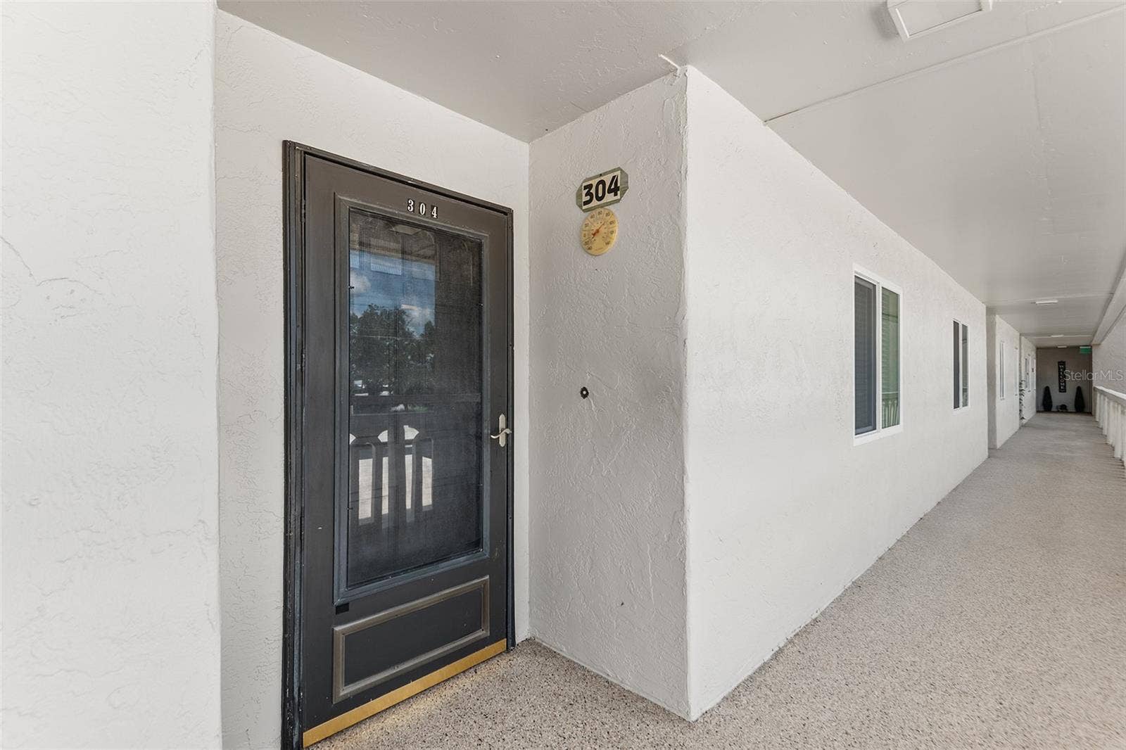 1776 6TH STREET NW, #304, Winter Haven, FL 33881 FRONT ENTRY OF UNIT. NOTE STORM DOOR.