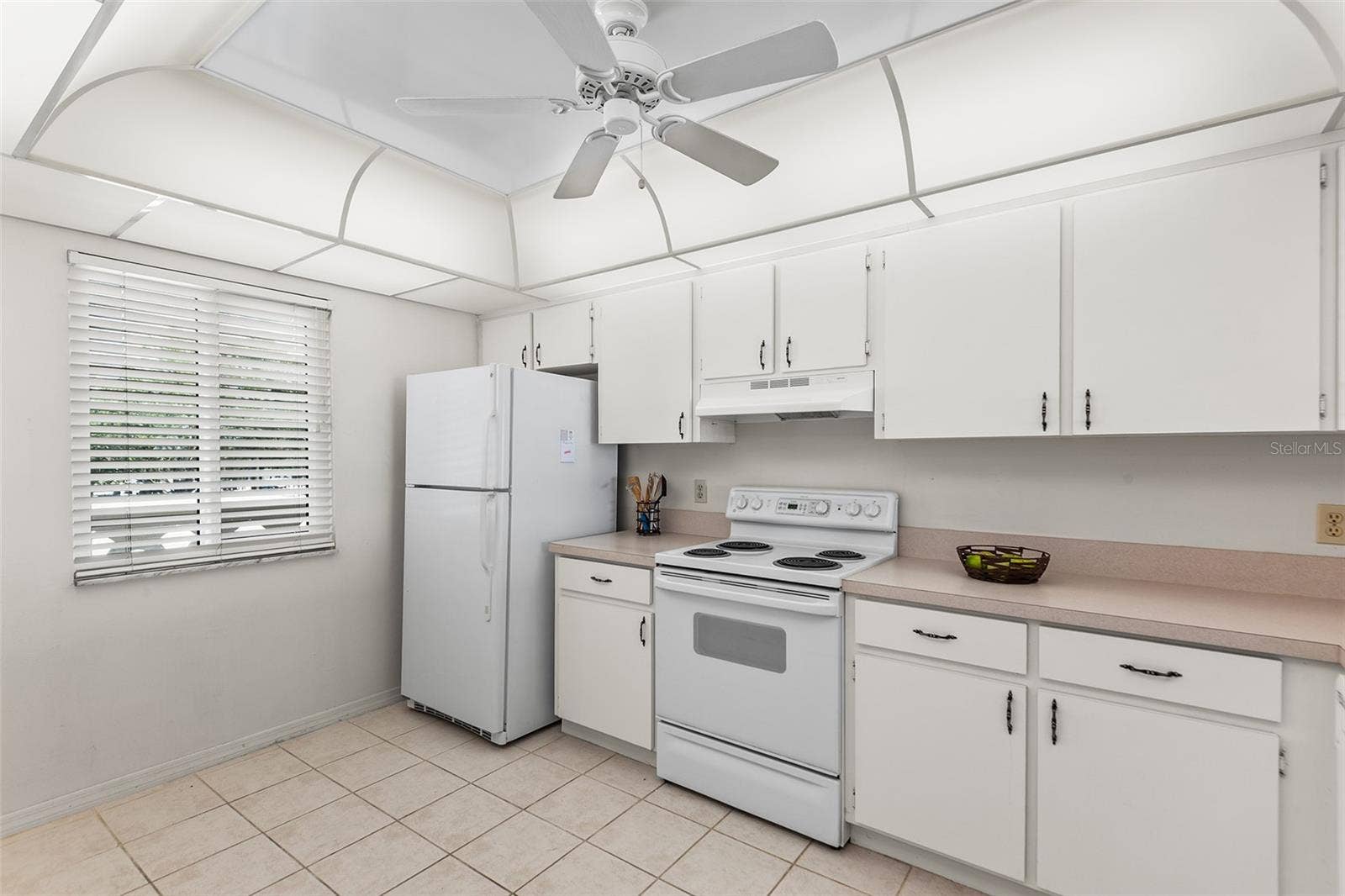 1776 6TH STREET NW, #304, Winter Haven, FL 33881 KITCHEN. NOTE EASY TO CARE FOR TILE FLOORING.