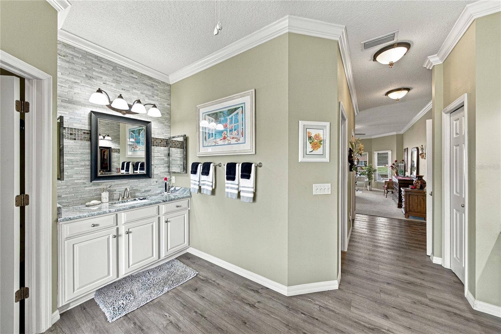 4232 DORNOCH DRIVE, Lake Wales, FL 33859 The west vanity also has stone countertops, stone wall with accents, and upgraded fixtures.