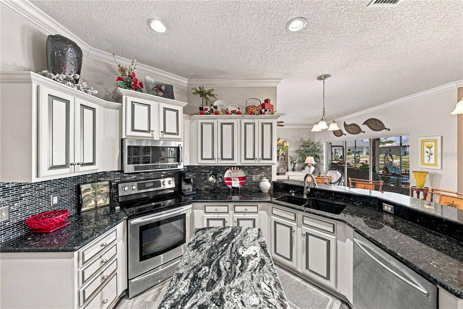 4232 DORNOCH DRIVE, Lake Wales, FL 33859 The granite countertops are enhanced by the glass backsplashes. The bank of drawers will be appreciated.