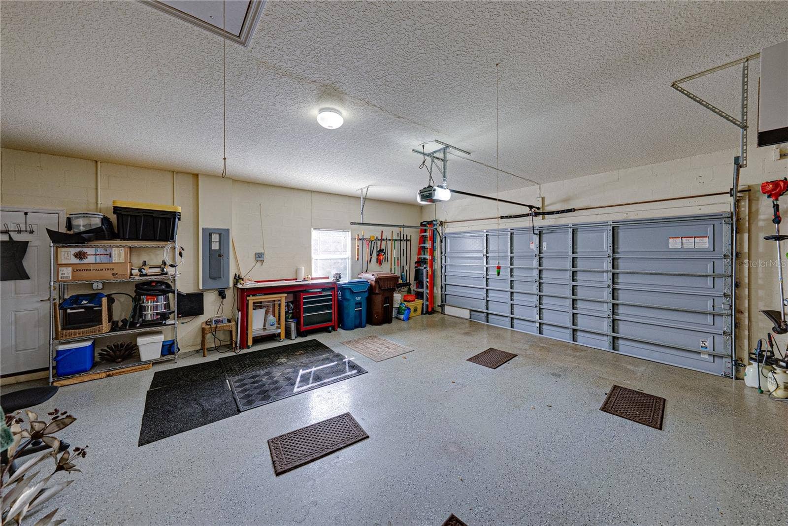 4232 DORNOCH DRIVE, Lake Wales, FL 33859 The attached 2 car garage has epoxy flooring, window, service door, and pull-down attic ladder.