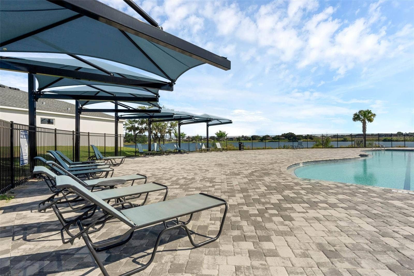2415 BRASSIE COURT, Winter Haven, FL 33884 Pavers are featured in the community pool lounging area