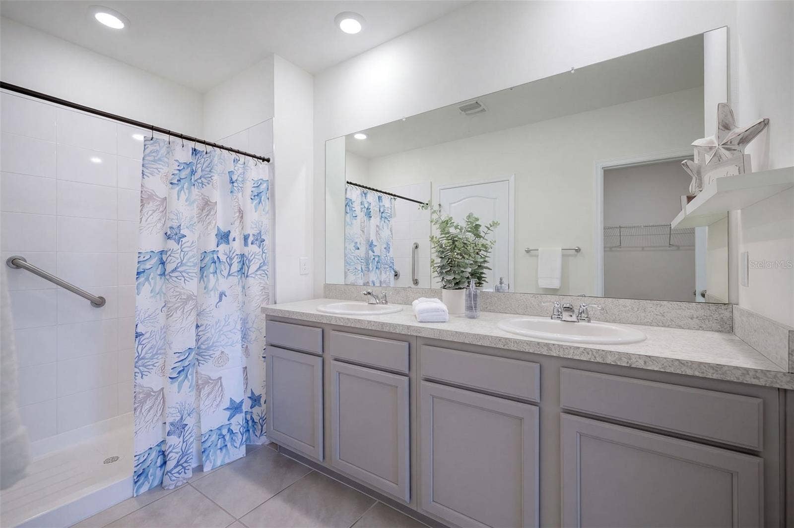 2415 BRASSIE COURT, Winter Haven, FL 33884 The Primary En-suite bathroom features a comfort-height vanity with dual sinks & a linen closet