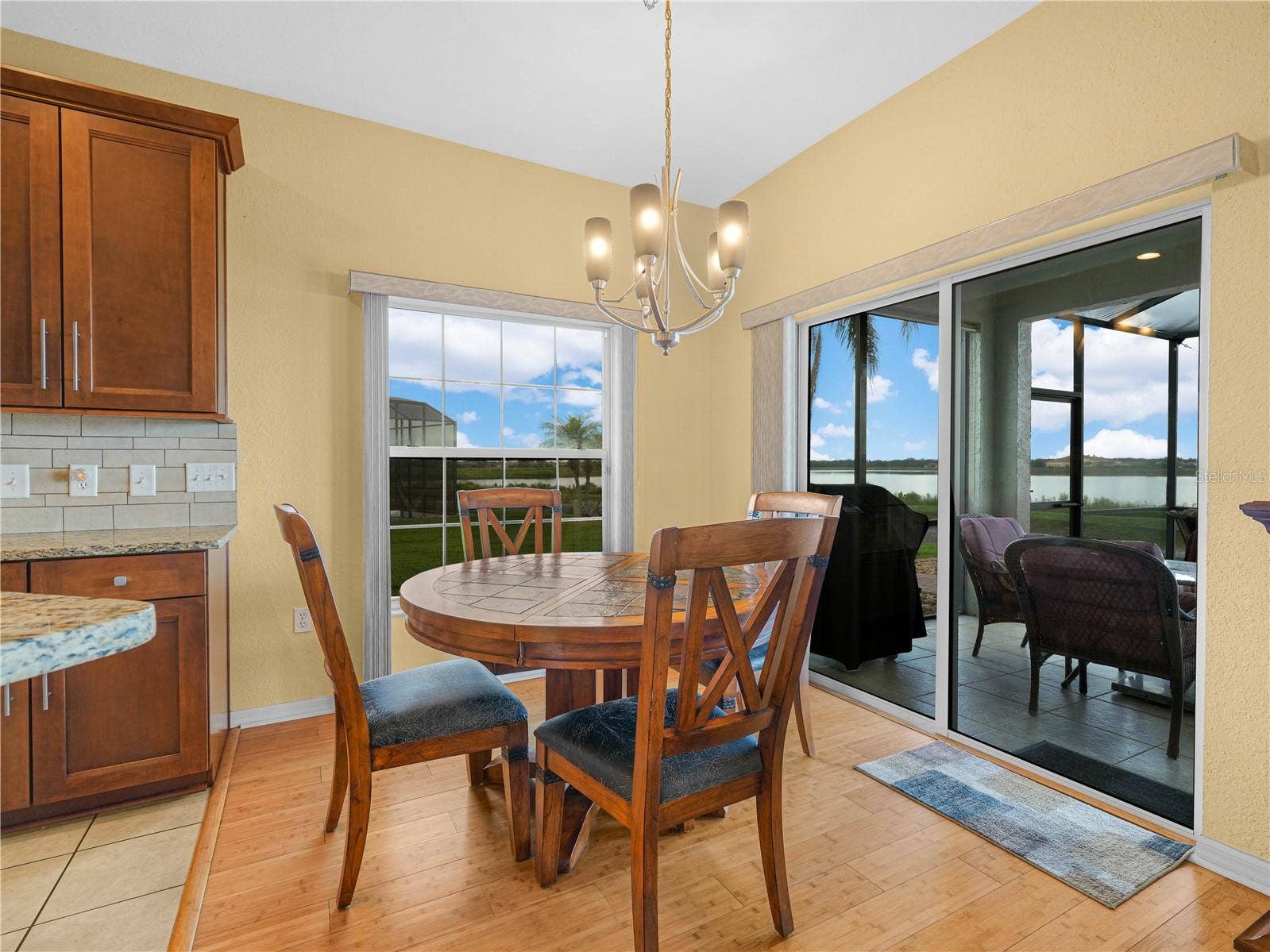 5385 HOGAN LANE, Winter Haven, FL 33884 Informal Dining Area. Double Sliders to the Covered and Screened Tiled Lanai
