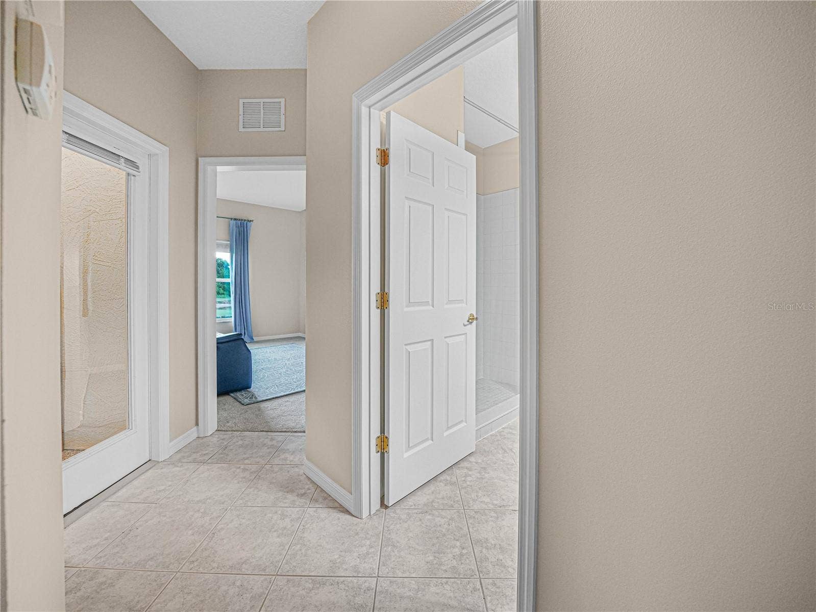 4299 ASHTON CLUB DRIVE, Lake Wales, FL 33859 Tiled Hallway to the Guest Bath, Bed 3 and Covered Florida Room