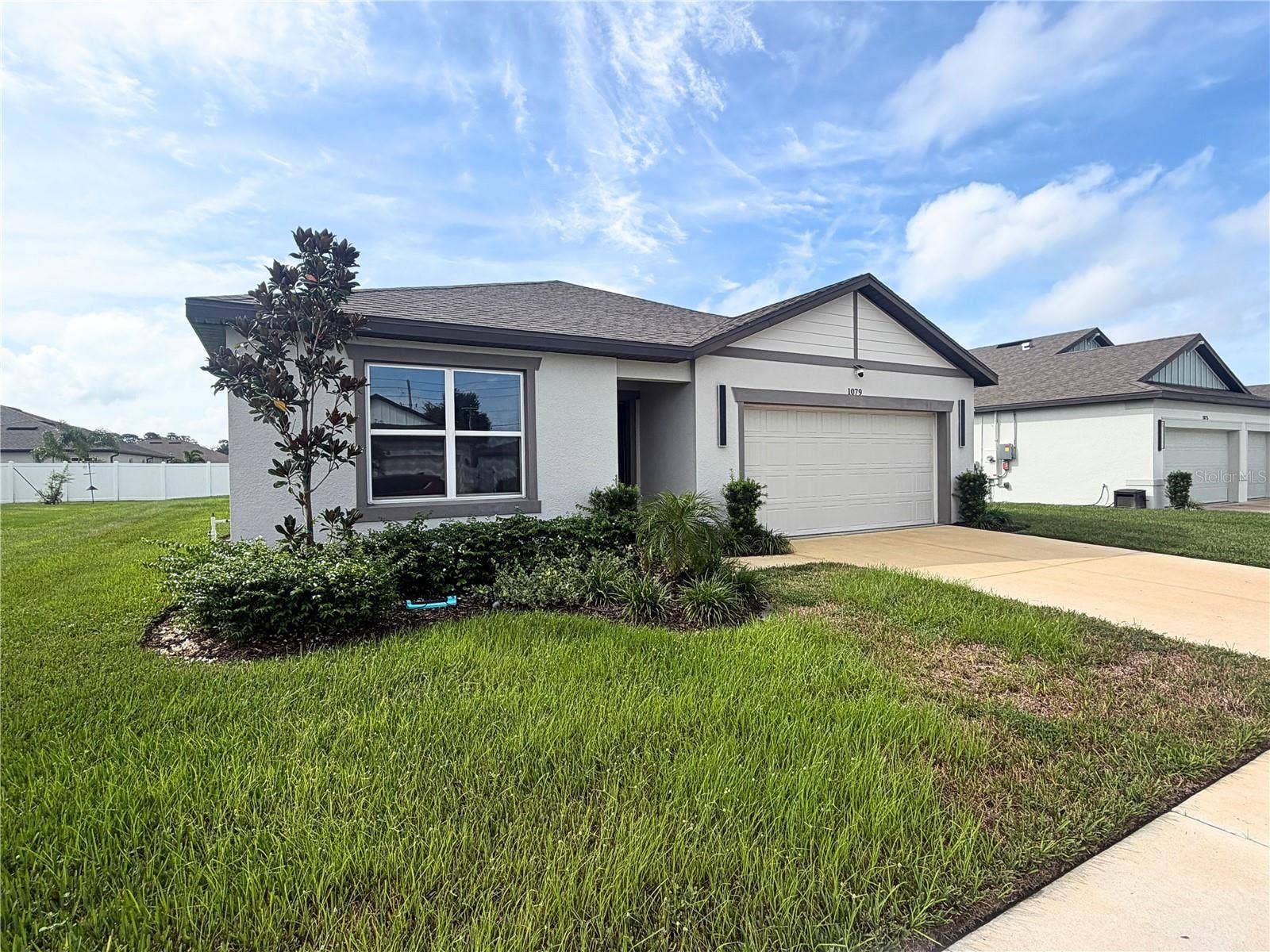 1079 MICHELANGELO LANE, Winter Haven, FL 33884 Two car garage and Florida friendly landscaping