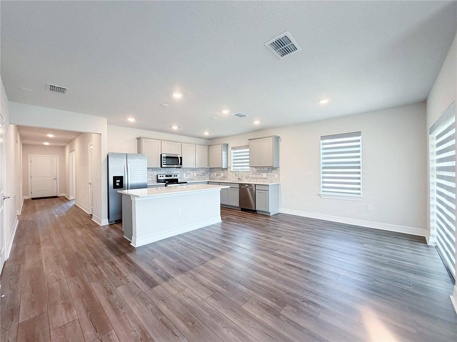 1079 MICHELANGELO LANE, Winter Haven, FL 33884 Hallway leads from the entry door to the open living space
