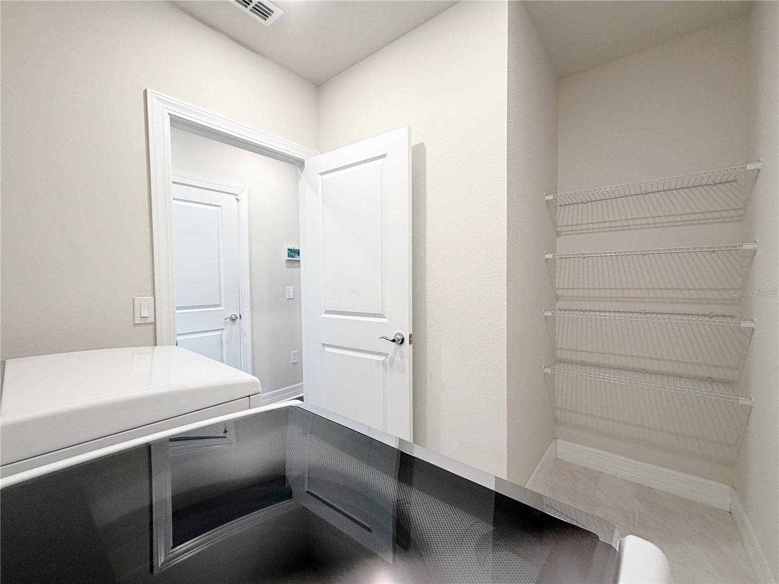 1079 MICHELANGELO LANE, Winter Haven, FL 33884 Laundry room offers plenty of storage space