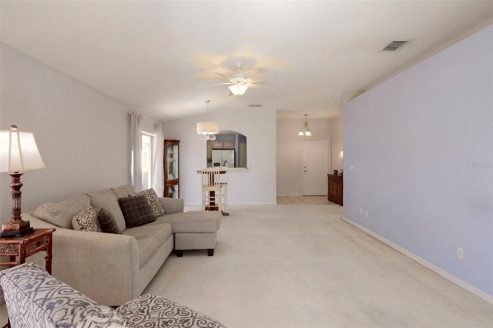 3437 GRENVILLE DRIVE, Winter Haven, FL 33884 Living room features a decorative planter shelf