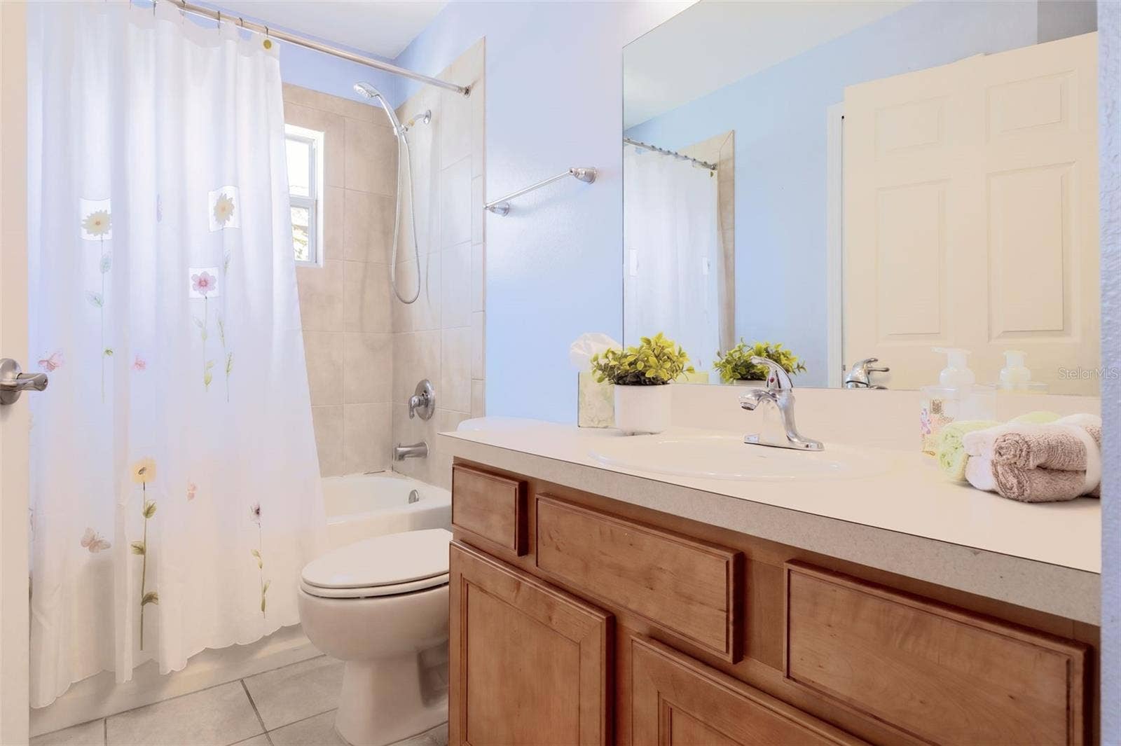 3437 GRENVILLE DRIVE, Winter Haven, FL 33884 Guest Bathroom with maple wood vanity and tub/shower unit