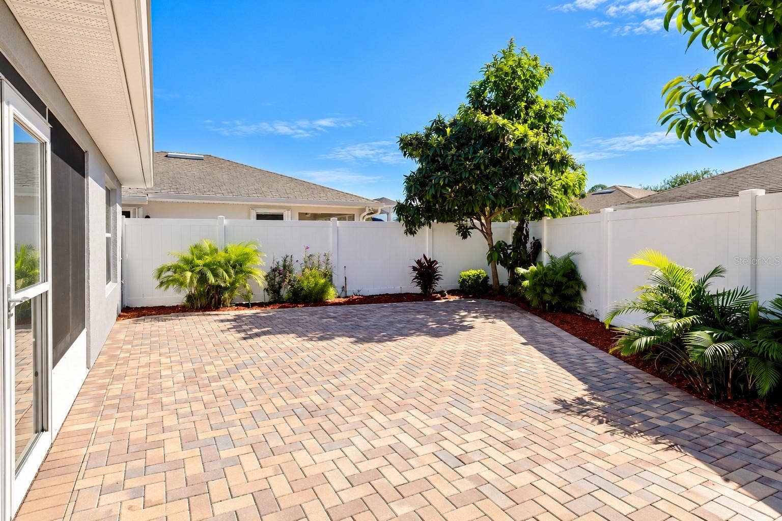 3437 GRENVILLE DRIVE, Winter Haven, FL 33884 Low-maintenance courtyard, enhanced with pavers and Florida-friendly landscaping, provides a private and inviting outdoor retreat.